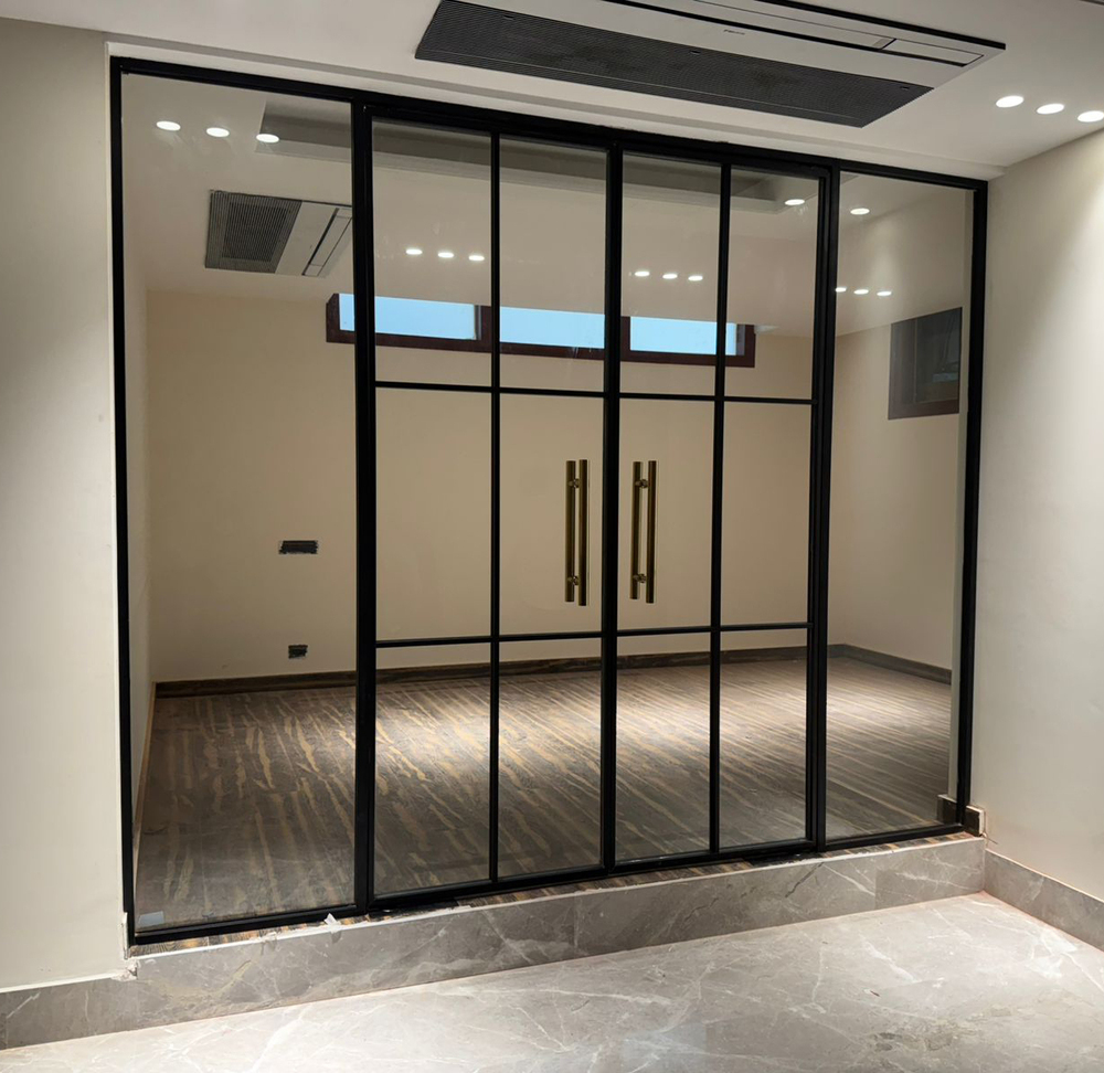 Aluminium partition with glass and panel sections in a workspace